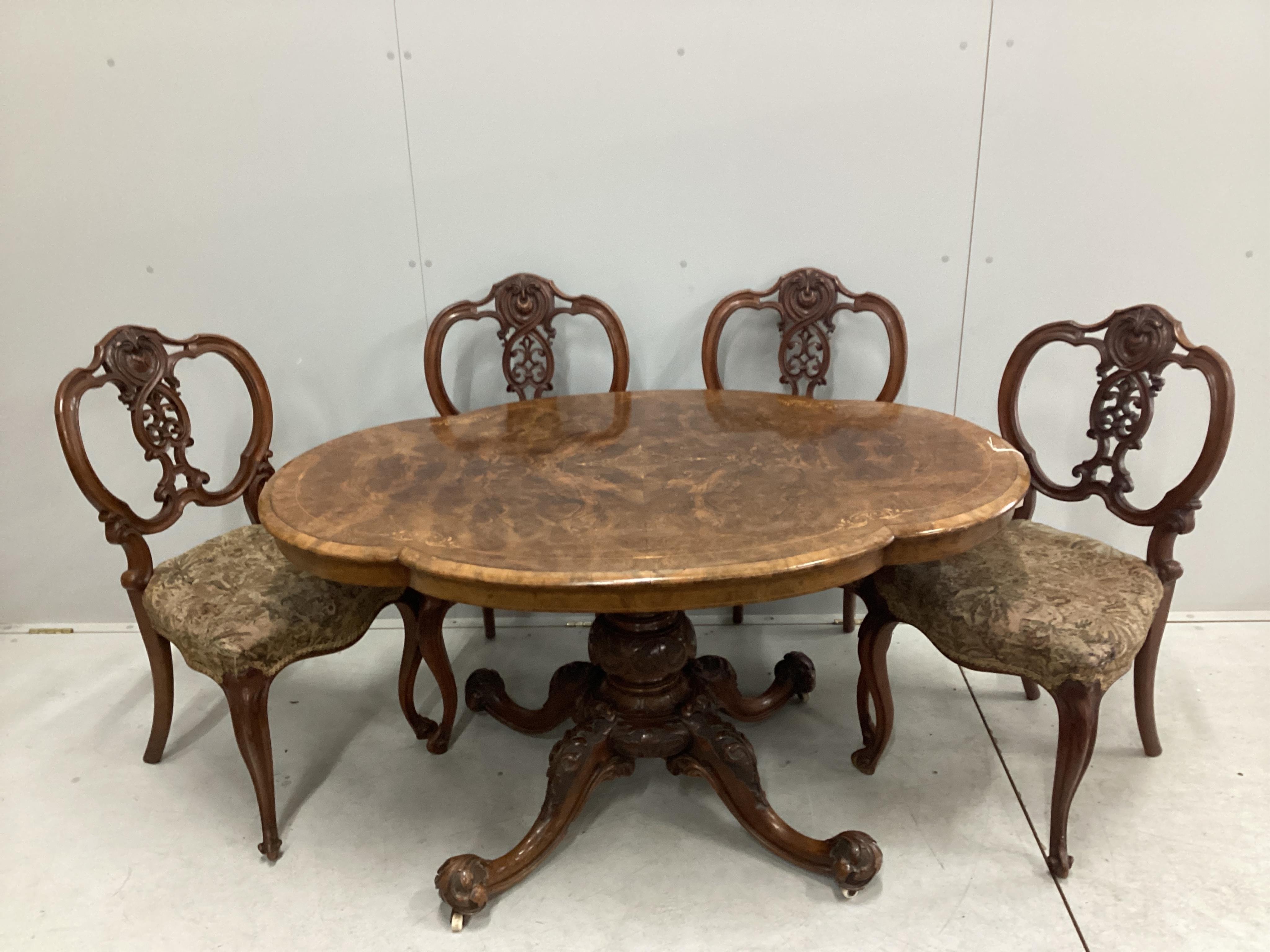 A set of four Victorian carved walnut dining chairs, bearing label - ‘’Taylor & Sons, Furniture Manufacturer, Dover Street, London’’, together with a mid Victorian inlaid walnut oval topped dining table, table width 130c